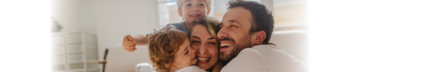 Family hugging in their home in New Jersey